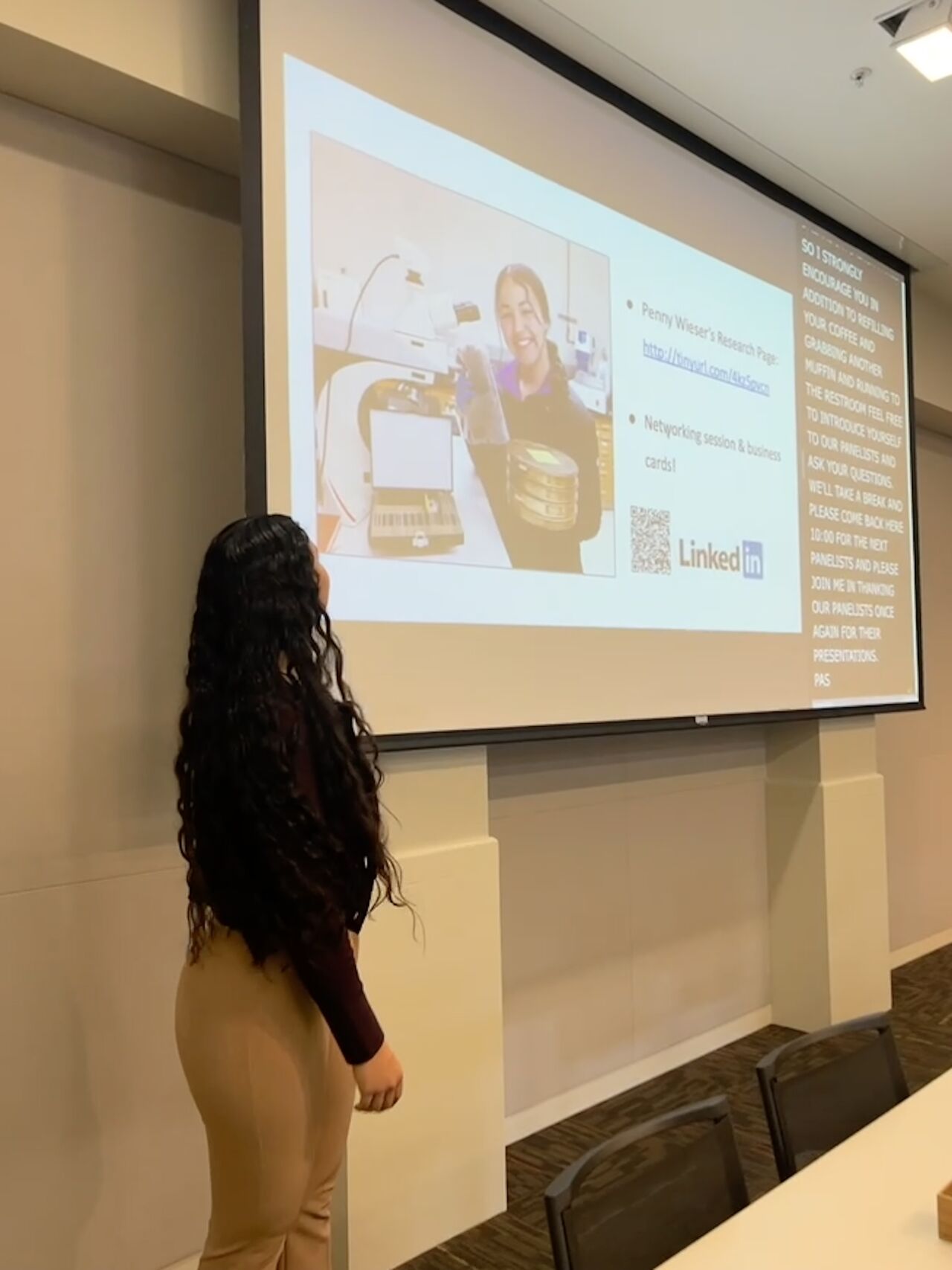 Student standing in front of projected slides