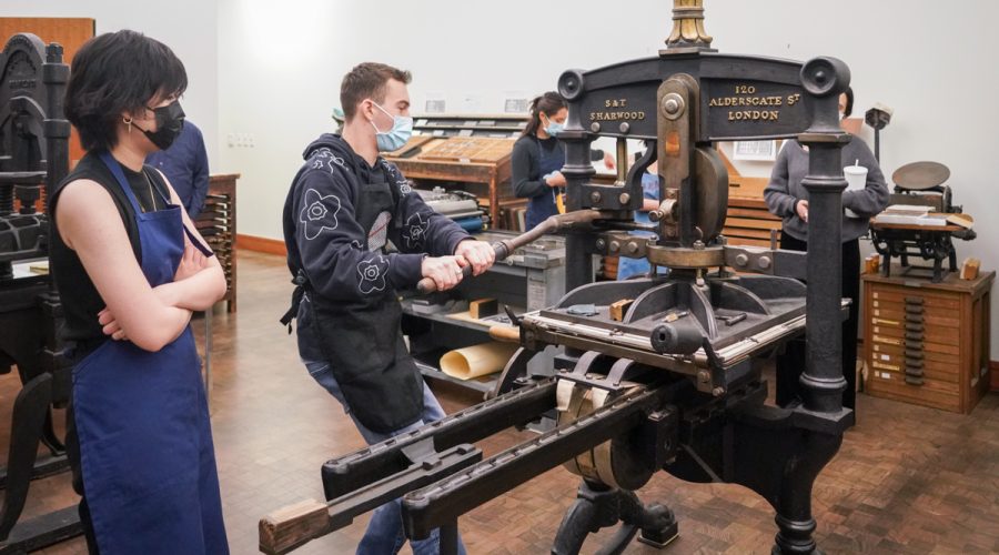 Students demonstrate printing a book for a class called The Hand-Printed Book in Its Historical Context, held in the Bancroft Library press room, on April 12, 2023. (Photo by Jami Smith/UC Berkeley Library)